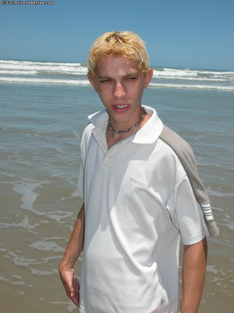 Blond twink Levi doffs his shirt and red undies and masturbates on the beach
