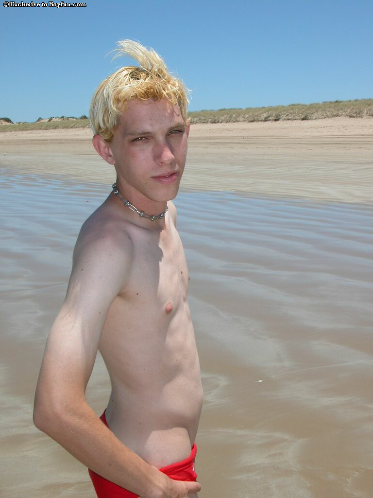 Blond twink Levi doffs his shirt and red undies and masturbates on the beach  
