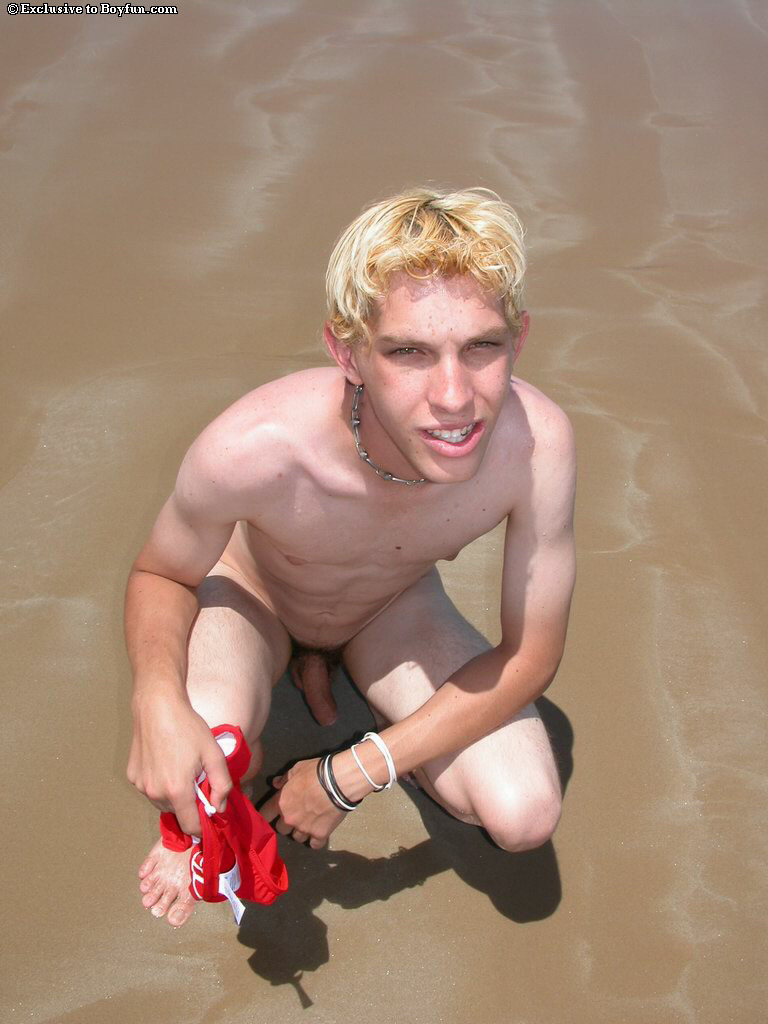 Blond twink Levi doffs his shirt and red undies and masturbates on the beach  