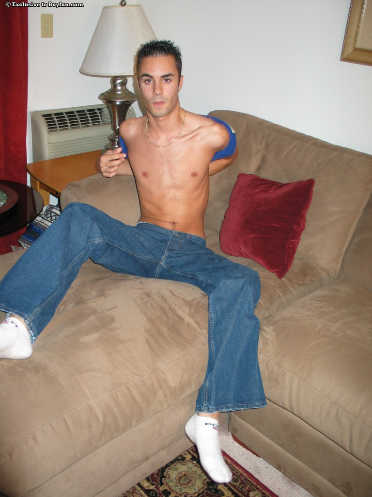 Sexy skinny gay Joey doffs his jeans and masturbates on the couch