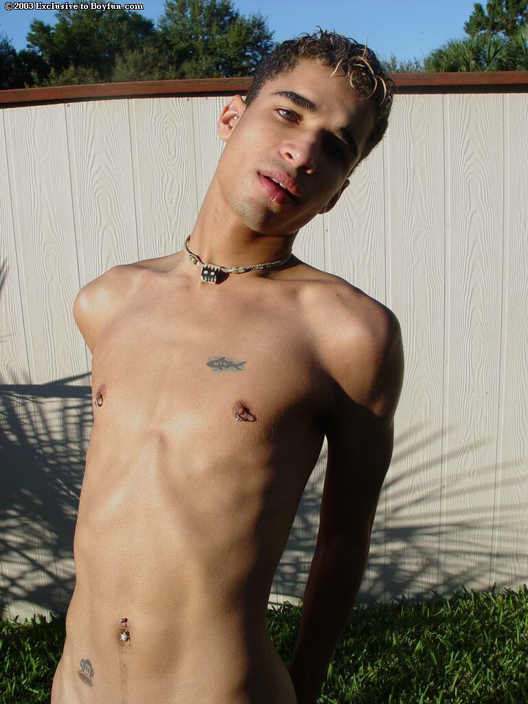 Naughty skinny gay Kahill reveals his body and pierced nips in the back yard  