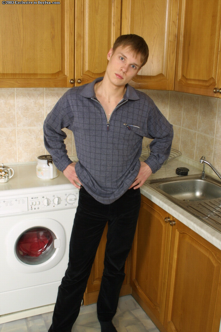 Handsome gay boy Yury strips in the kitchen and massages his uncut dick